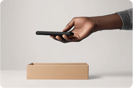 image of mobile being placed in a box DE